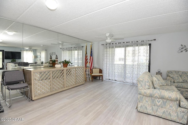 living room with wood-type flooring and ceiling fan