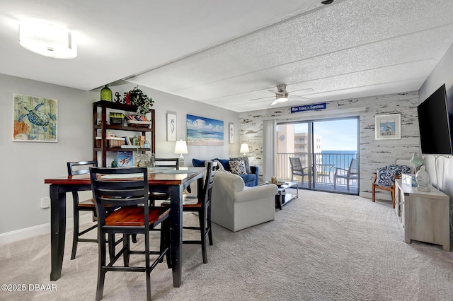 carpeted dining space featuring ceiling fan