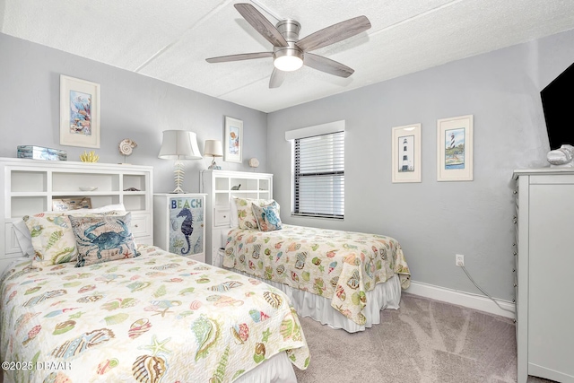 carpeted bedroom featuring ceiling fan and a textured ceiling