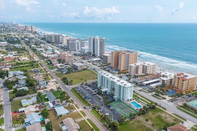 drone / aerial view with a beach view and a water view