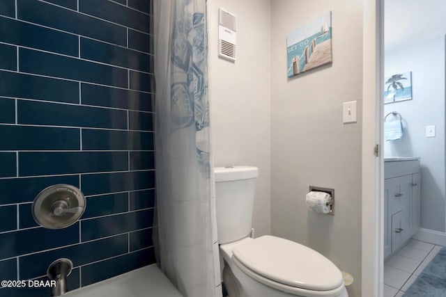 bathroom with vanity, toilet, curtained shower, and tile patterned flooring