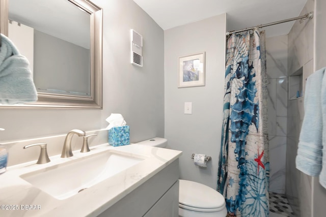 bathroom featuring vanity, curtained shower, and toilet