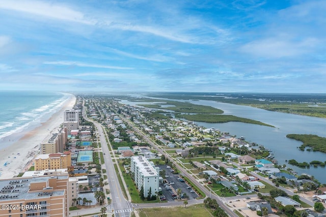 birds eye view of property with a water view and a view of the beach