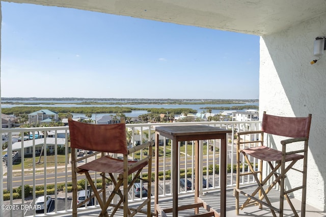 balcony featuring a water view