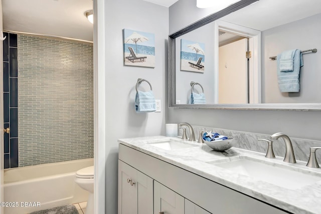 full bathroom with vanity, tiled shower / bath, tile patterned floors, and toilet