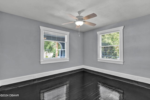 spare room featuring hardwood / wood-style floors and ceiling fan