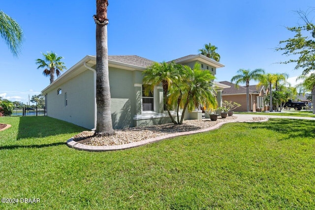 view of front of home featuring a garage and a front lawn