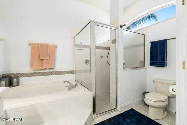 bathroom with separate shower and tub, toilet, and tile patterned floors