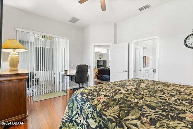 bedroom with hardwood / wood-style floors, ceiling fan, and connected bathroom