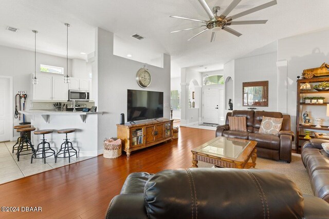 living room with light wood-type flooring and ceiling fan