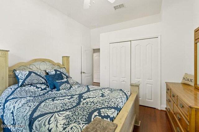 bedroom with a closet, ceiling fan, and dark hardwood / wood-style floors