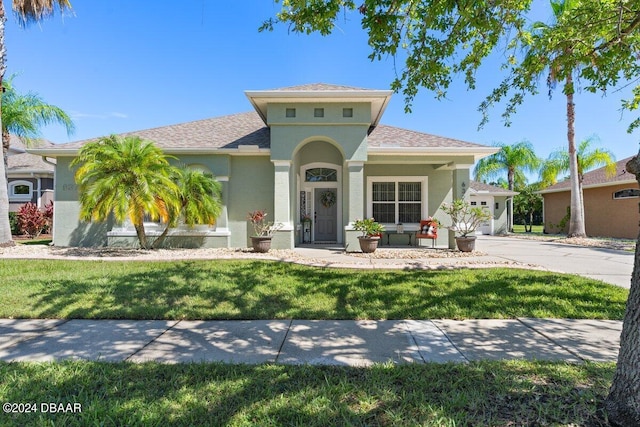 mediterranean / spanish-style house with a garage and a front yard