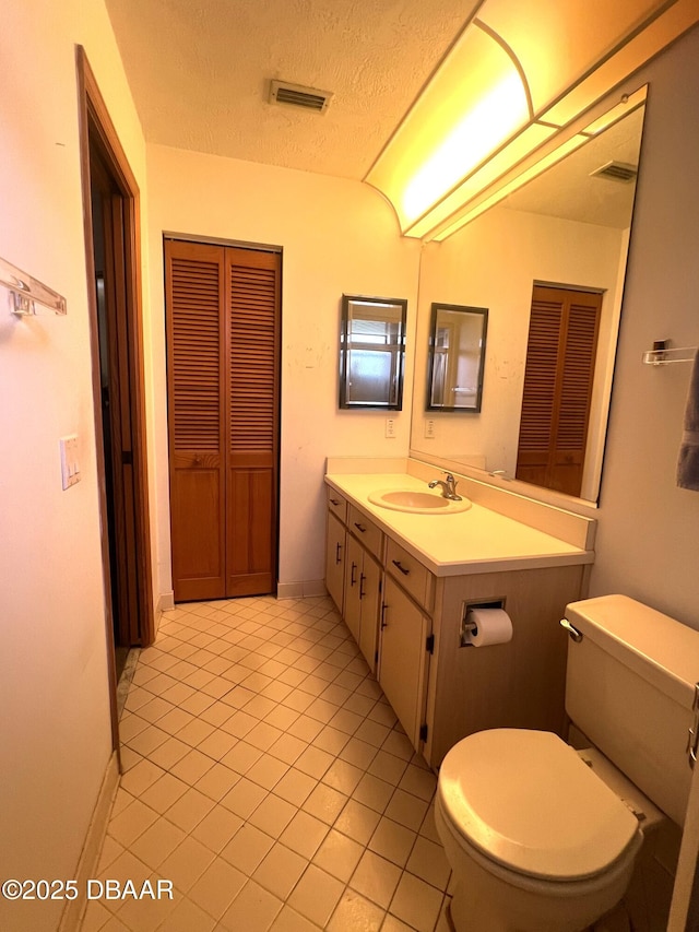 112 Underbrush Trl, Port Orange, FL 32128 - bathroom featuring vanity, a closet, tile patterned floors, and a textured ceiling