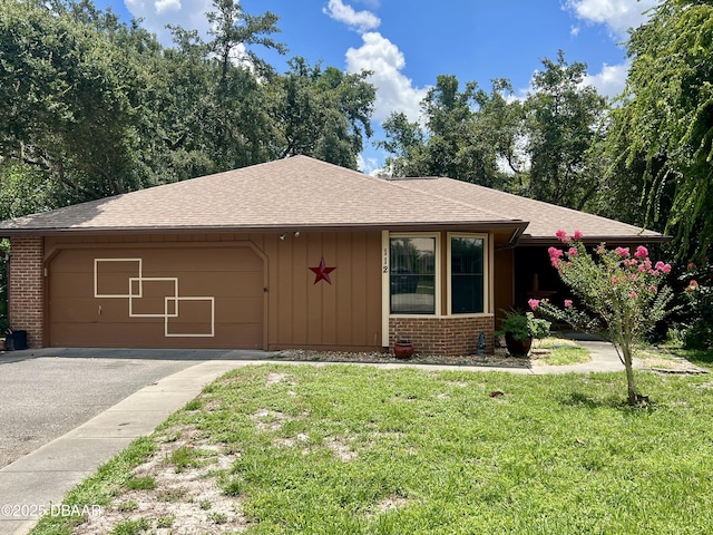 112 Underbrush Trl, Port Orange, FL 32128 - view of front facade featuring brick siding, board and batten siding, driveway, and a garage