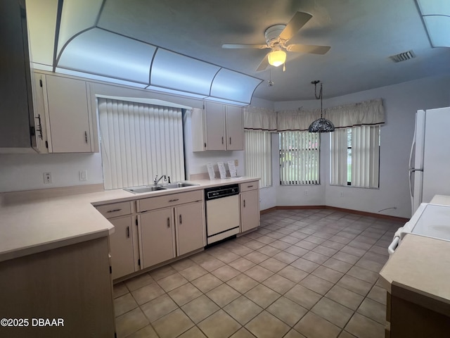 112 Underbrush Trl, Port Orange, FL 32128 - kitchen with white appliances, light countertops, white cabinets, and a ceiling fan