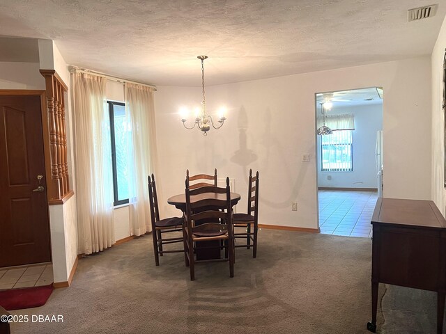 112 Underbrush Trl, Port Orange, FL 32128 - tiled dining area featuring carpet, a chandelier, and a textured ceiling