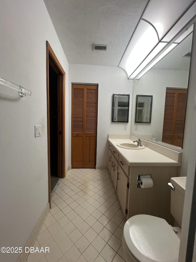 112 Underbrush Trl, Port Orange, FL 32128 - bathroom featuring vanity, a textured ceiling, a closet, and tile patterned floors