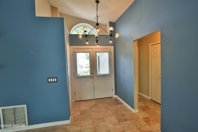3455 Saddleback Ct, Port Orange, FL 32129 - entryway with a chandelier, a textured ceiling, french doors, baseboards, and high vaulted ceiling