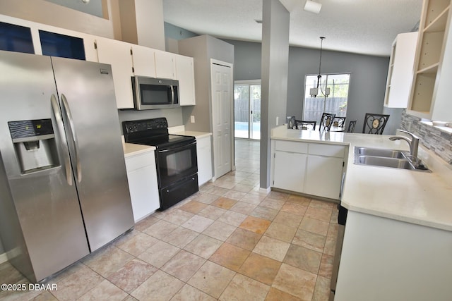 3455 Saddleback Ct, Port Orange, FL 32129 - kitchen featuring appliances with stainless steel finishes, a sink, vaulted ceiling, light countertops, and white cabinets