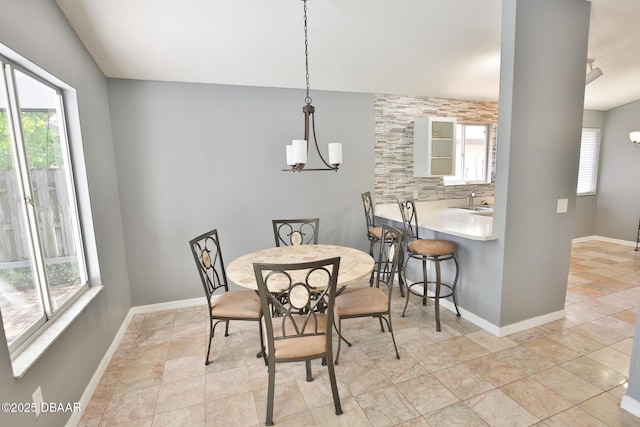 3455 Saddleback Ct, Port Orange, FL 32129 - dining area featuring baseboards and a chandelier