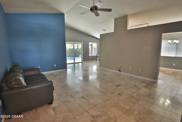 3455 Saddleback Ct, Port Orange, FL 32129 - unfurnished living room with a textured ceiling, ceiling fan, a chandelier, lofted ceiling, and baseboards