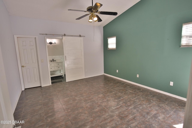 3455 Saddleback Ct, Port Orange, FL 32129 - unfurnished bedroom featuring multiple windows, vaulted ceiling, baseboards, and a ceiling fan