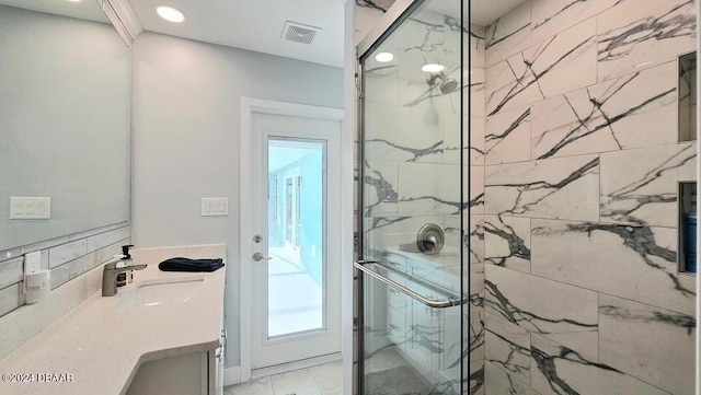 full bath featuring marble finish floor, a marble finish shower, visible vents, and vanity