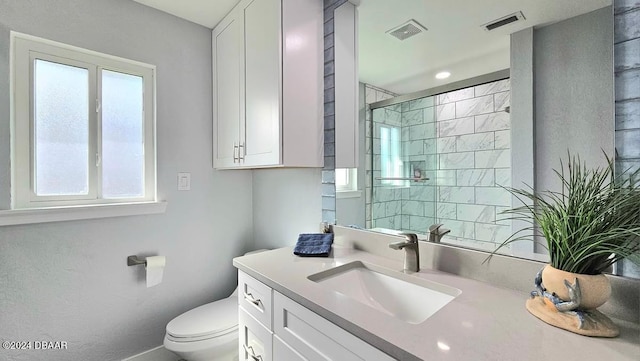 full bath featuring a wealth of natural light, a stall shower, and visible vents