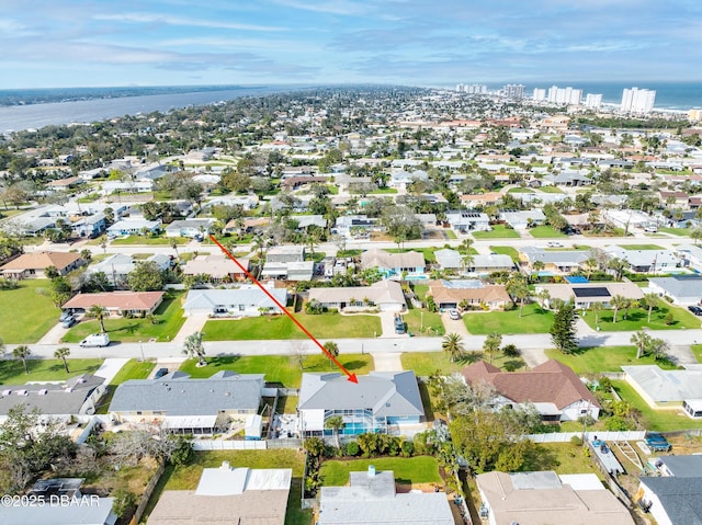 bird's eye view featuring a water view and a residential view