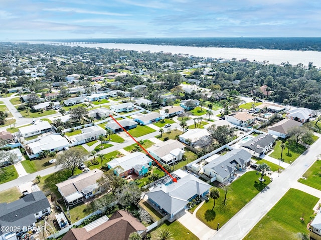 drone / aerial view with a water view and a residential view