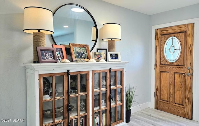 foyer with baseboards and light wood finished floors