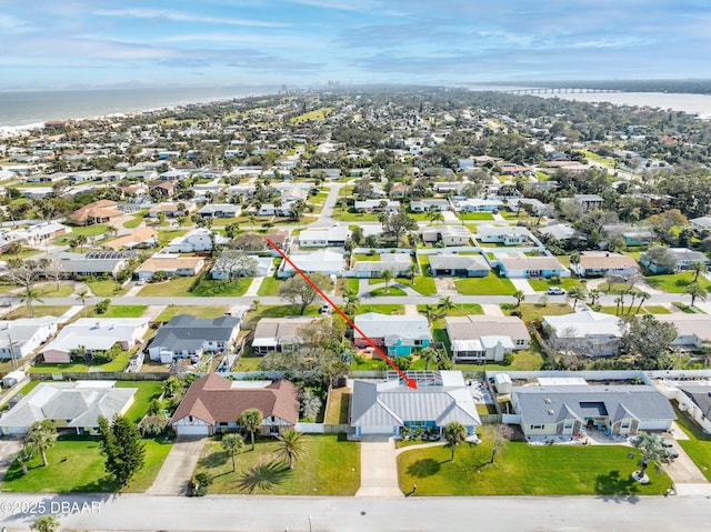 birds eye view of property with a water view and a residential view