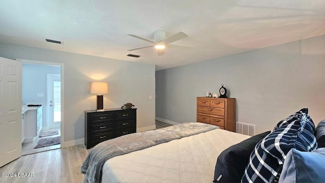 bedroom featuring baseboards, visible vents, and light wood finished floors