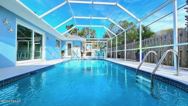 view of pool with a patio, a lanai, a fenced in pool, and fence