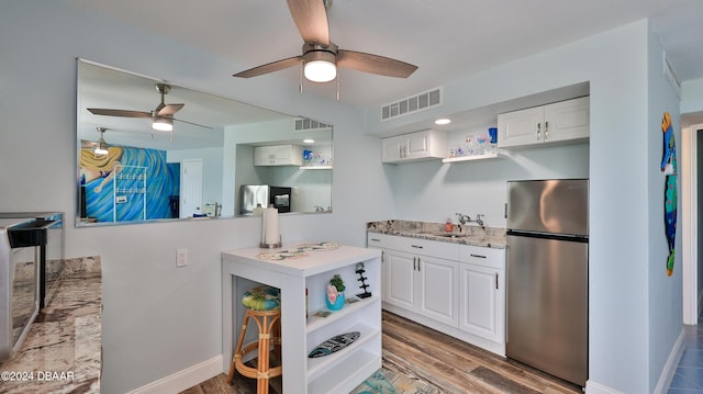 219 S Atlantic Ave Unit 440, Daytona Beach, FL 32118 - kitchen with freestanding refrigerator, open shelves, and ceiling fan