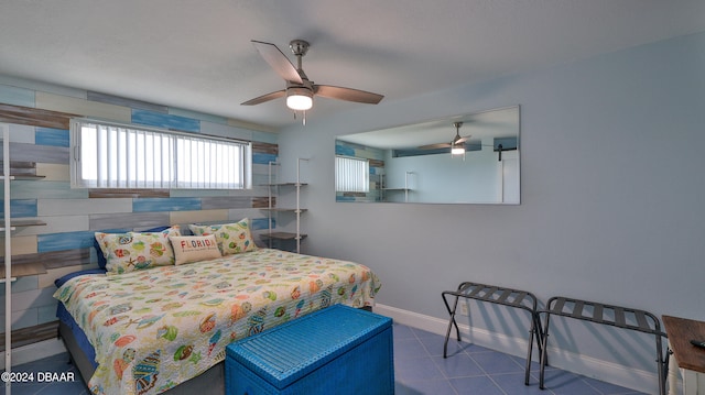 bedroom with ceiling fan and tile walls