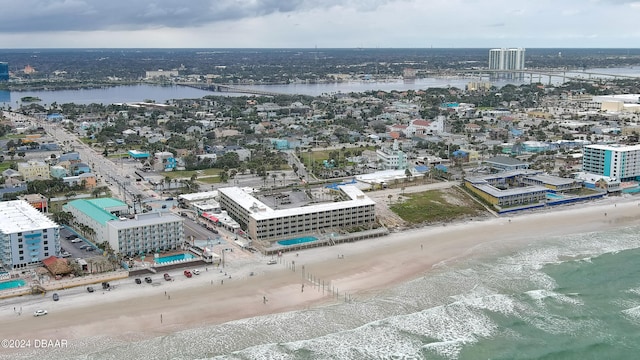 birds eye view of property featuring a beach view and a water view