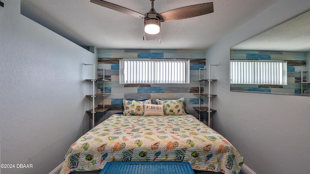219 S Atlantic Ave Unit 440, Daytona Beach, FL 32118 - bedroom featuring baseboards, ceiling fan, and a textured wall