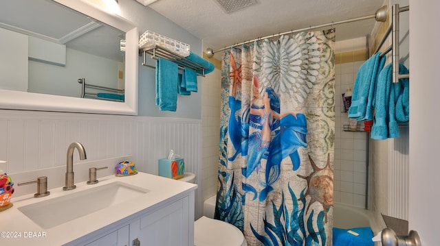 full bathroom featuring vanity, a textured ceiling, toilet, and shower / tub combo with curtain