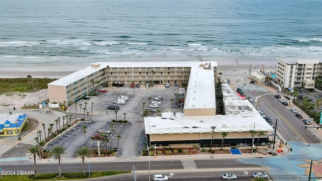 drone / aerial view featuring a water view and a view of the beach