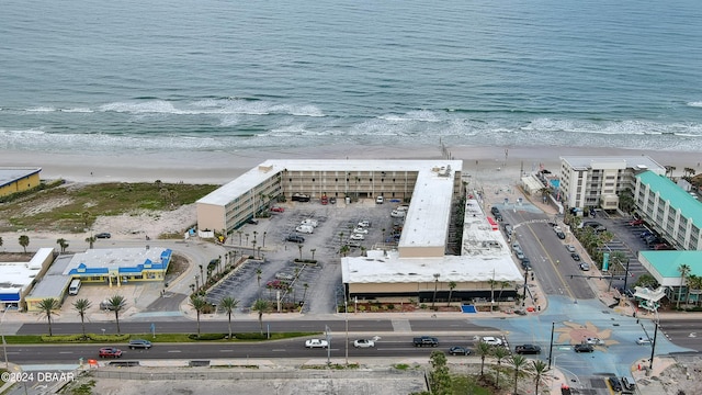 drone / aerial view with a water view and a view of the beach