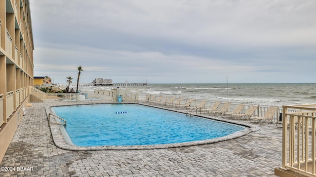 219 S Atlantic Ave Unit 440, Daytona Beach, FL 32118 - community pool featuring fence, a patio area, and view of water and beach