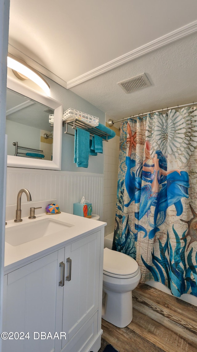 full bathroom featuring wood-type flooring, vanity, shower / bath combo, and toilet