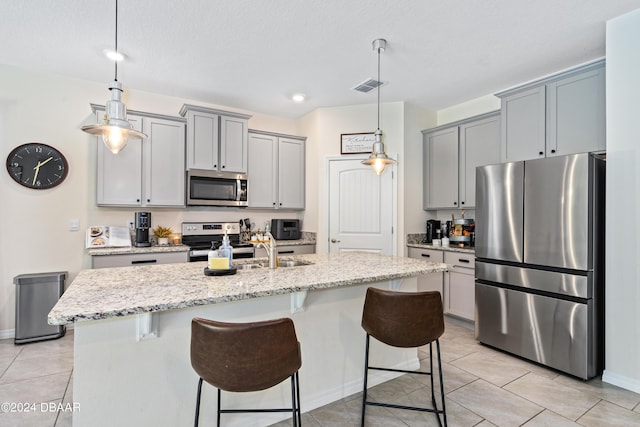1743 Red Rock Rd, New Smyrna Beach, FL 32168 - kitchen with appliances with stainless steel finishes, a breakfast bar area, light stone countertops, and light tile patterned flooring