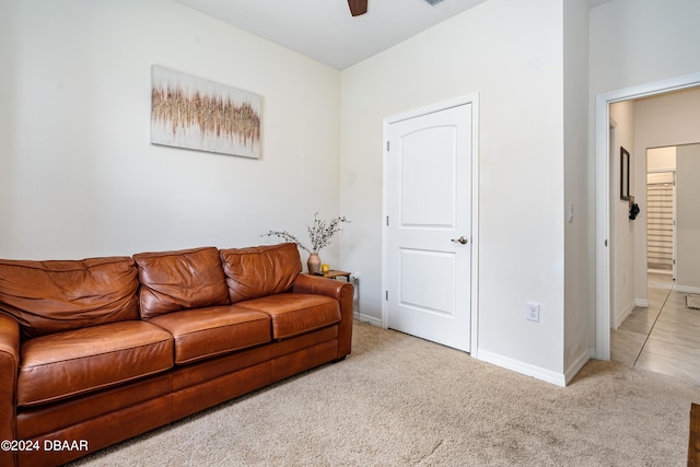 living room featuring ceiling fan and carpet