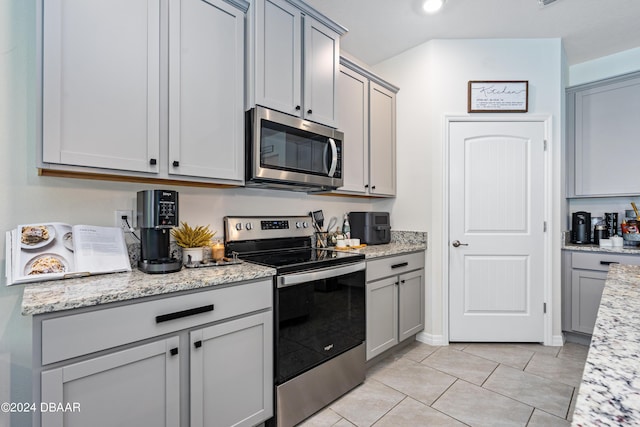 1743 Red Rock Rd, New Smyrna Beach, FL 32168 - kitchen featuring stainless steel appliances, gray cabinets, light tile patterned floors, and light stone counters