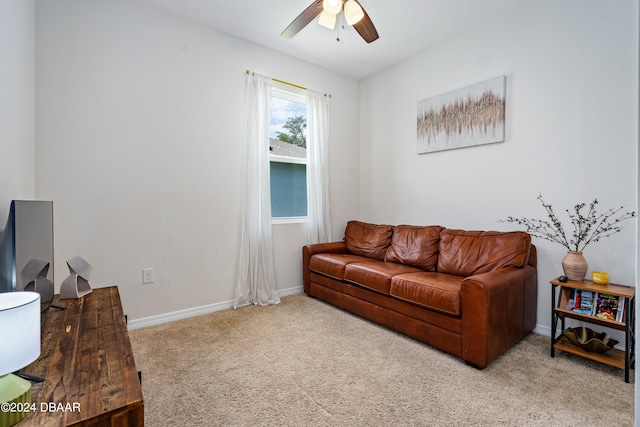 carpeted living room with ceiling fan