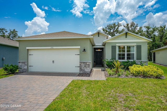 view of front of house with a garage and a front lawn