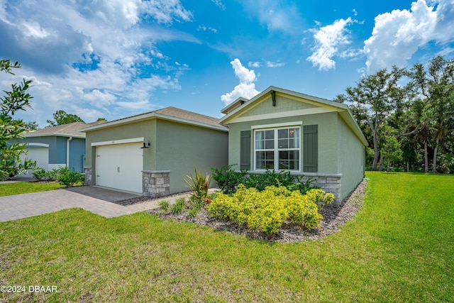 ranch-style house featuring a garage and a front yard