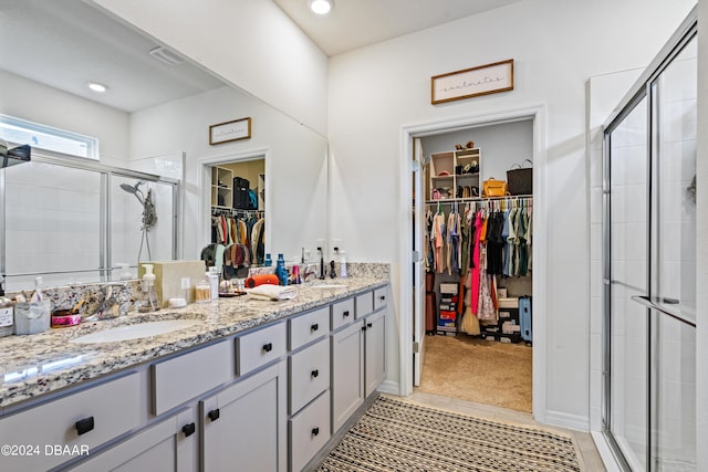 bathroom featuring vanity and a shower with door